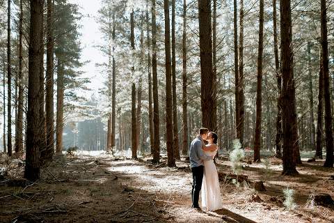 couple kissing in forest