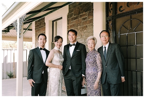groom with family in front of house
