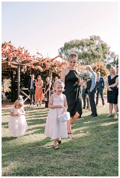 Flowergirls walking down aisle currant shed