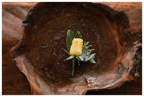 Yellow rose on wood bowl