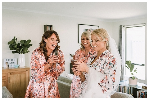 Bride laughing at text message