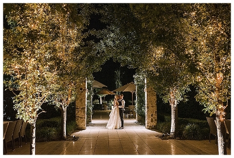 bride and groom kissing at night time at golding wines
